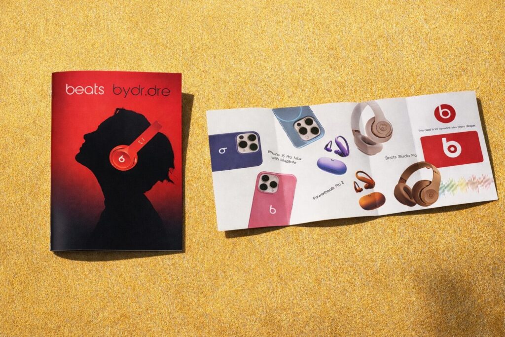 Beats by Dre branding guide and brochure layout displayed on a gold textured background