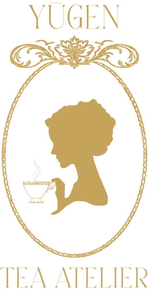 Primary packaging logo for Yūgen Tea Atelier featuring an ornate gold frame with a stylized silhouette holding a teacup.